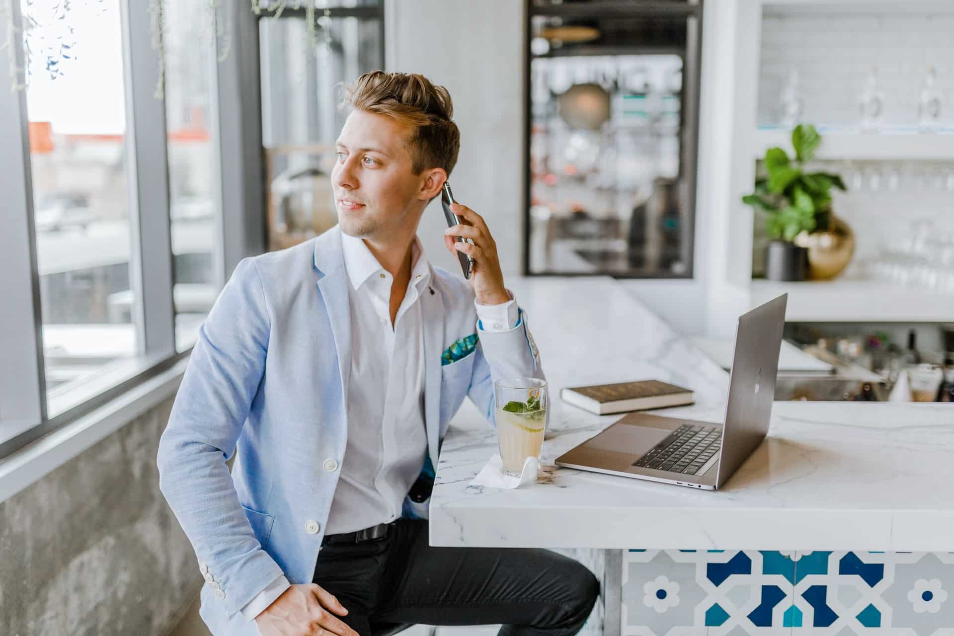 man in suit talking to someone on the phone